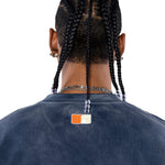Rear view Male Model wearing a navy sweatshirt with the 'NY Tough' logo on the neck.