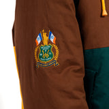 Brown jacket with a embroidered  WOA Liberty patch on the sleeve against a white background.