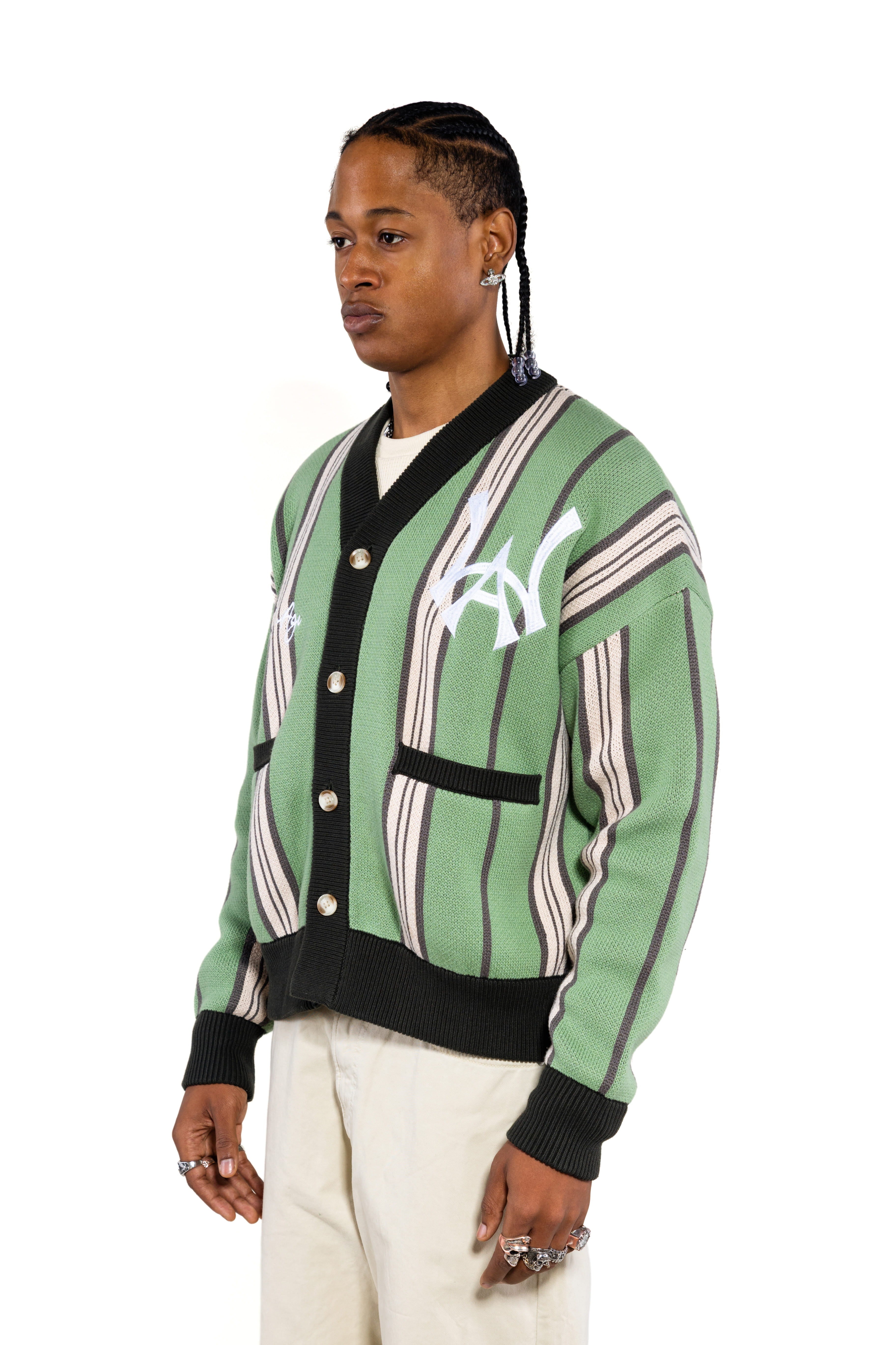 Close, sideview of a Male model wearing the WOA City cardigan mint on a white background. 'WA Logo' embroidered on the left chest.