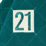 Close up of the number 21 within a cream box on the right chest of the WOA knit rugby polo.