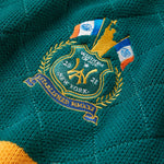 Close up of the embroidered Wisdom of age NY state patch on the left shoulder. The patch features a silhoutte of the Statue Of Liberty holding a firearm, 2 New York state flags, the WA logo the number 20 on the left, the number 21 on the right in gold thread.