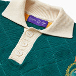 Close up Front View of the Wisdom of age Lemon rugby. A cream collar and buttons along with the signature purple wisdom of age tag. There is a Wisdom of age NY state patch visible on the right.