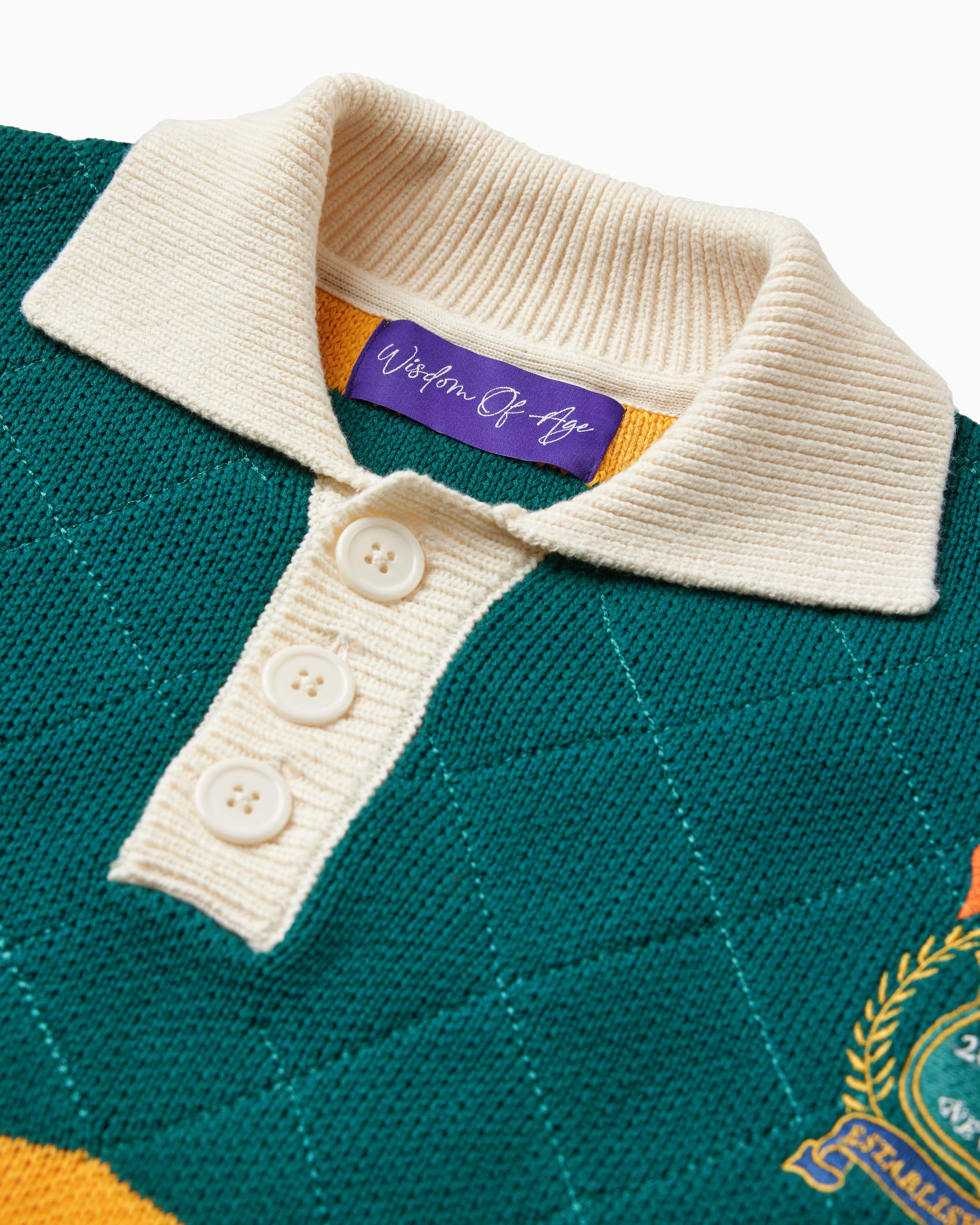 Close up Front View of the Wisdom of age Lemon rugby. A cream collar and buttons along with the signature purple wisdom of age tag. There is a Wisdom of age NY state patch visible on the right.