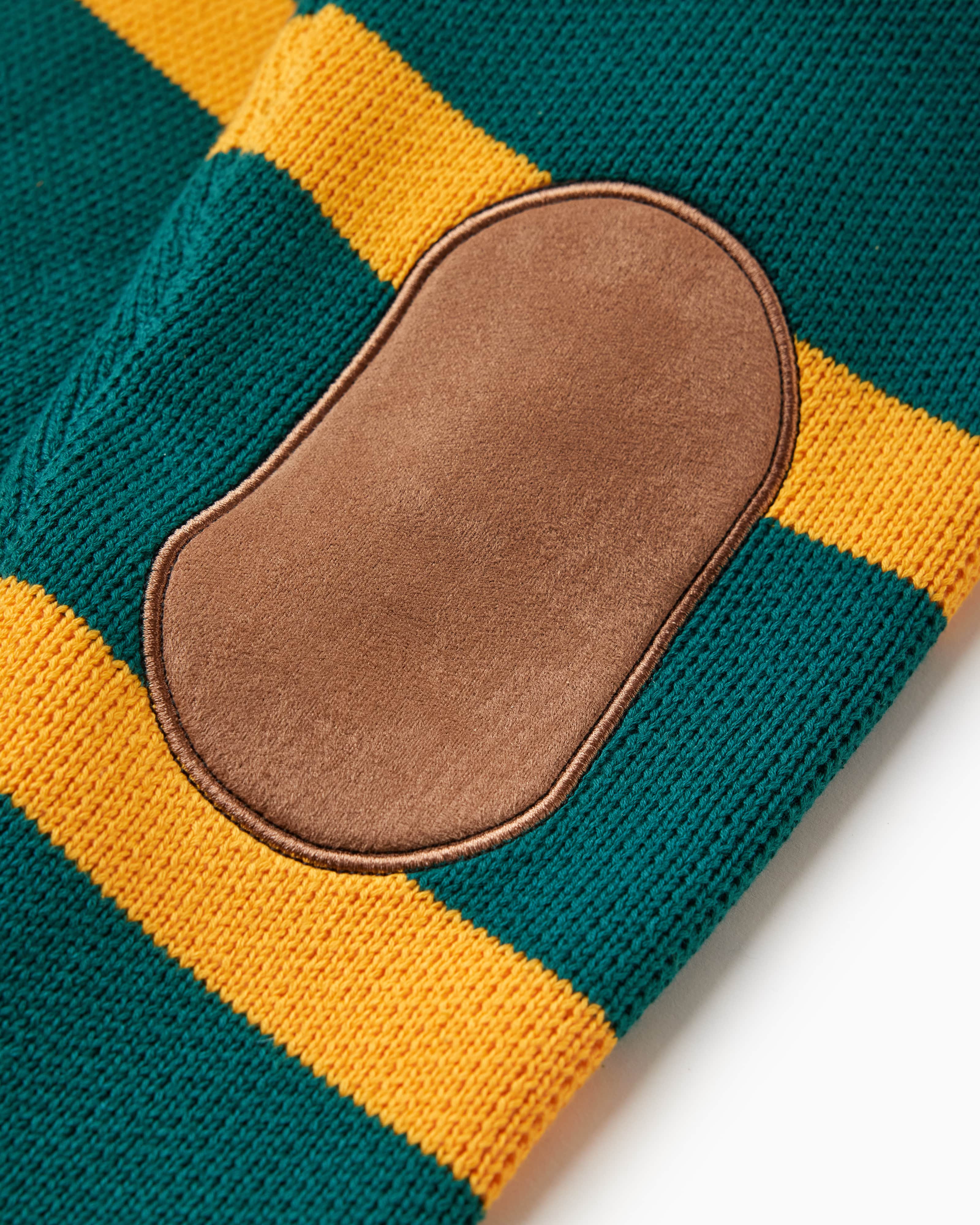 Close up of the brown suede elbow patches on the back of each sleeve of the WOA knit Rugby polo sweater.