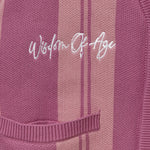 'Wisdom of Age' embroidered on a Pink striped garment. 