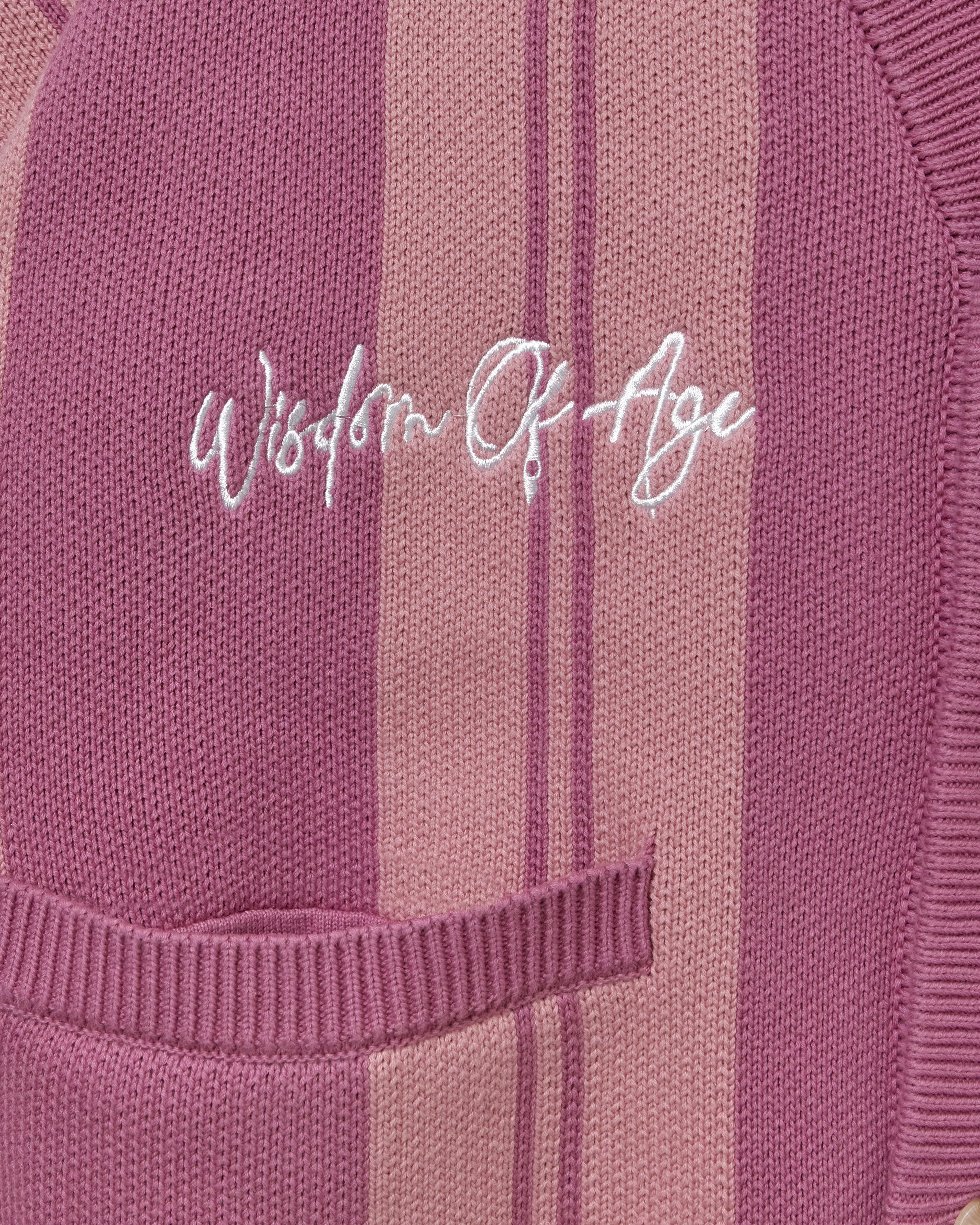 'Wisdom of Age' embroidered on a Pink striped garment. 