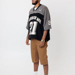 Side view Male Model wearing the WOA Football jersey V2 Slate with number 21 on a white background