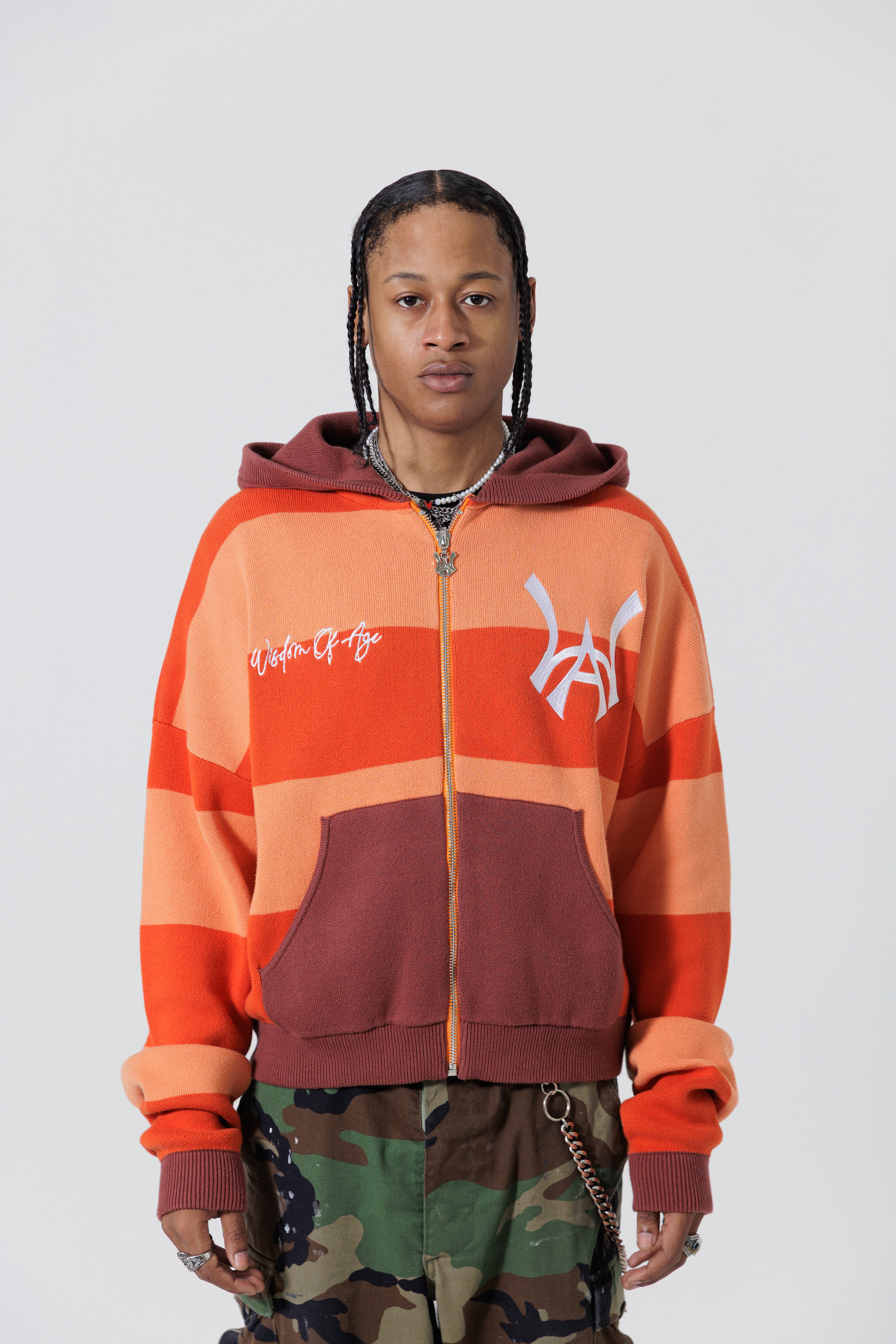 Front View Of A Male Model wearing The Wisdom Of Age Knit Hoodie Orange.
