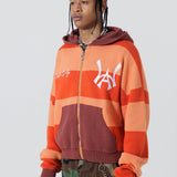 Front Side View Of A Male Model wearing The Wisdom Of Age Knit Hoodie Orange.