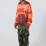 Front Full Body View Of A Male Model wearing The Wisdom Of Age Knit Hoodie Orange.