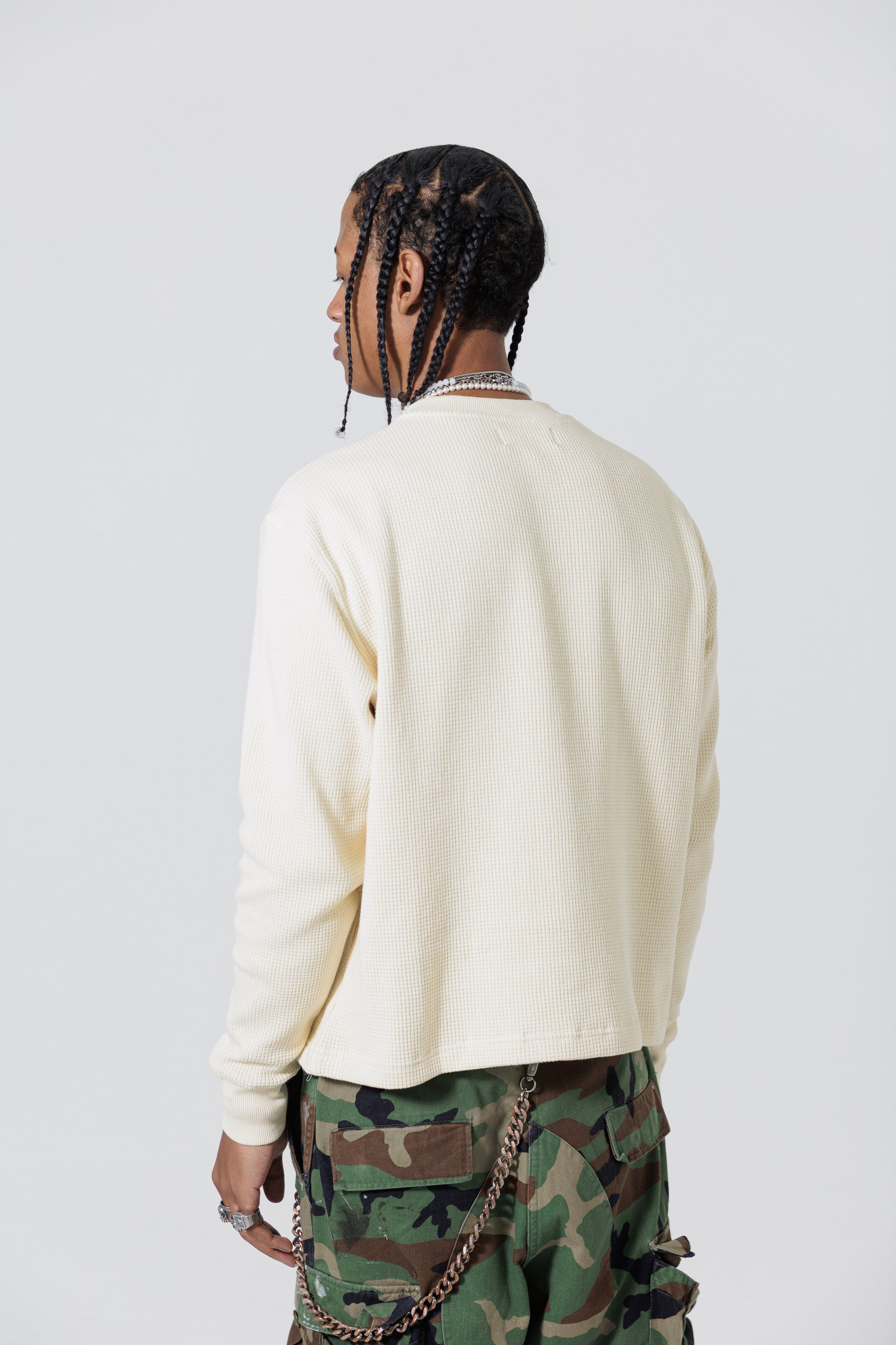 Rear view of a Male Model Wearing Cream Wisdom Of Age knit thermal