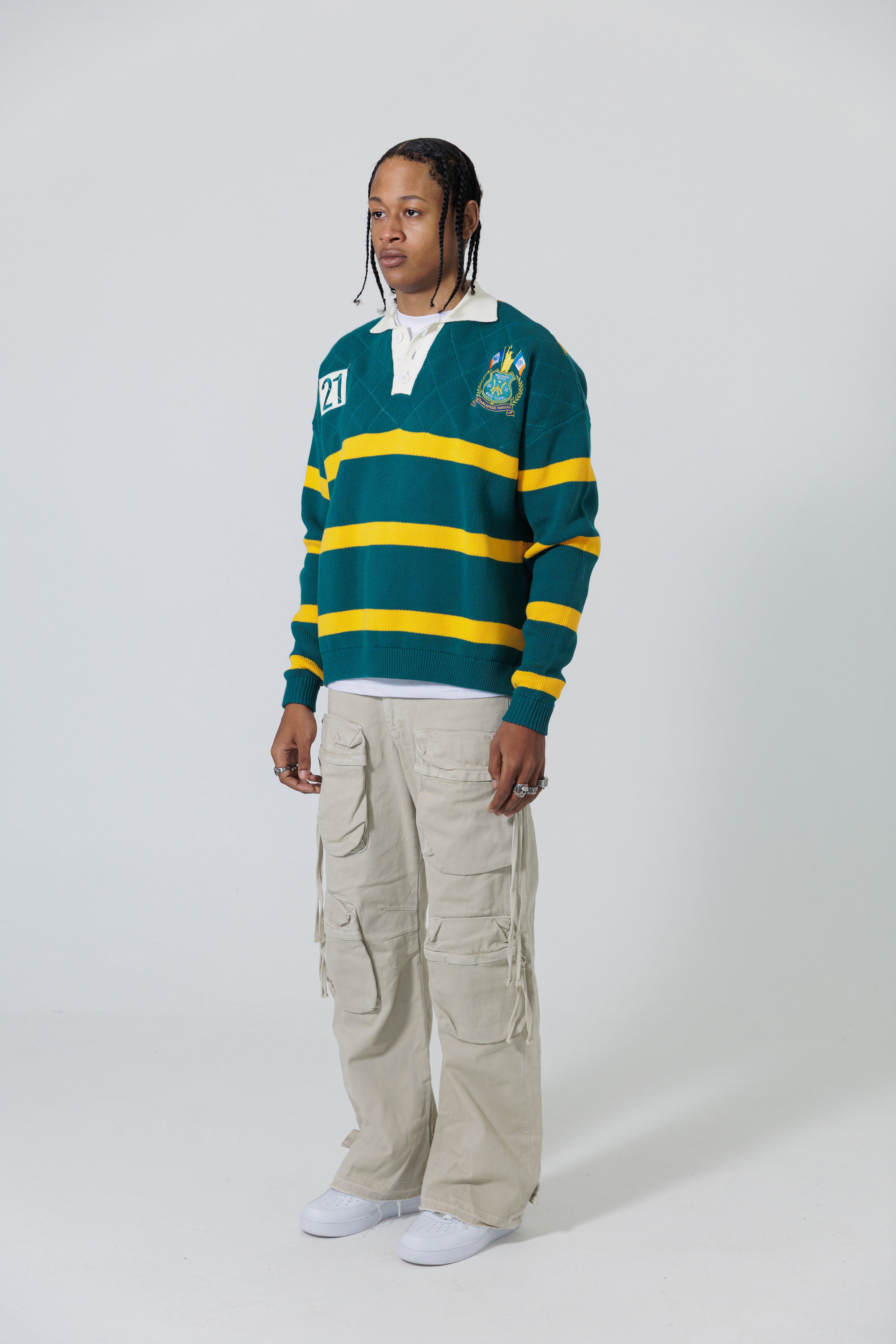 Full Body Front View Of A Male Model wearing The Wisdom Of Age Knit Rugby Sweater.
