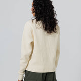 Rear view of a Female Model Wearing Cream Wisdom Of Age knit thermal