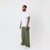Side view of Male Model wearing a white t-shirt and the WOA Cargos in Olive color on a white background.
