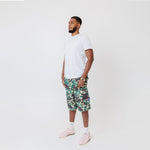 Side view Male Model wearing a white t-shirt and the WOA convertible Cargos in Camo color on a white background.