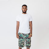 Male Model wearing a white t-shirt and the WOA convertible Cargo shorts in Camo color on a white background.