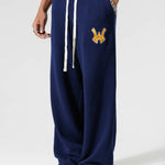 Male Model Wearing The Wisdom Of Age Knit Clinton Sweatpants Navy Front View With his hand in the pocket.