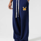 Male Model Wearing The Wisdom Of Age Knit Clinton Sweatpants Navy Front View With his hand in the pocket.