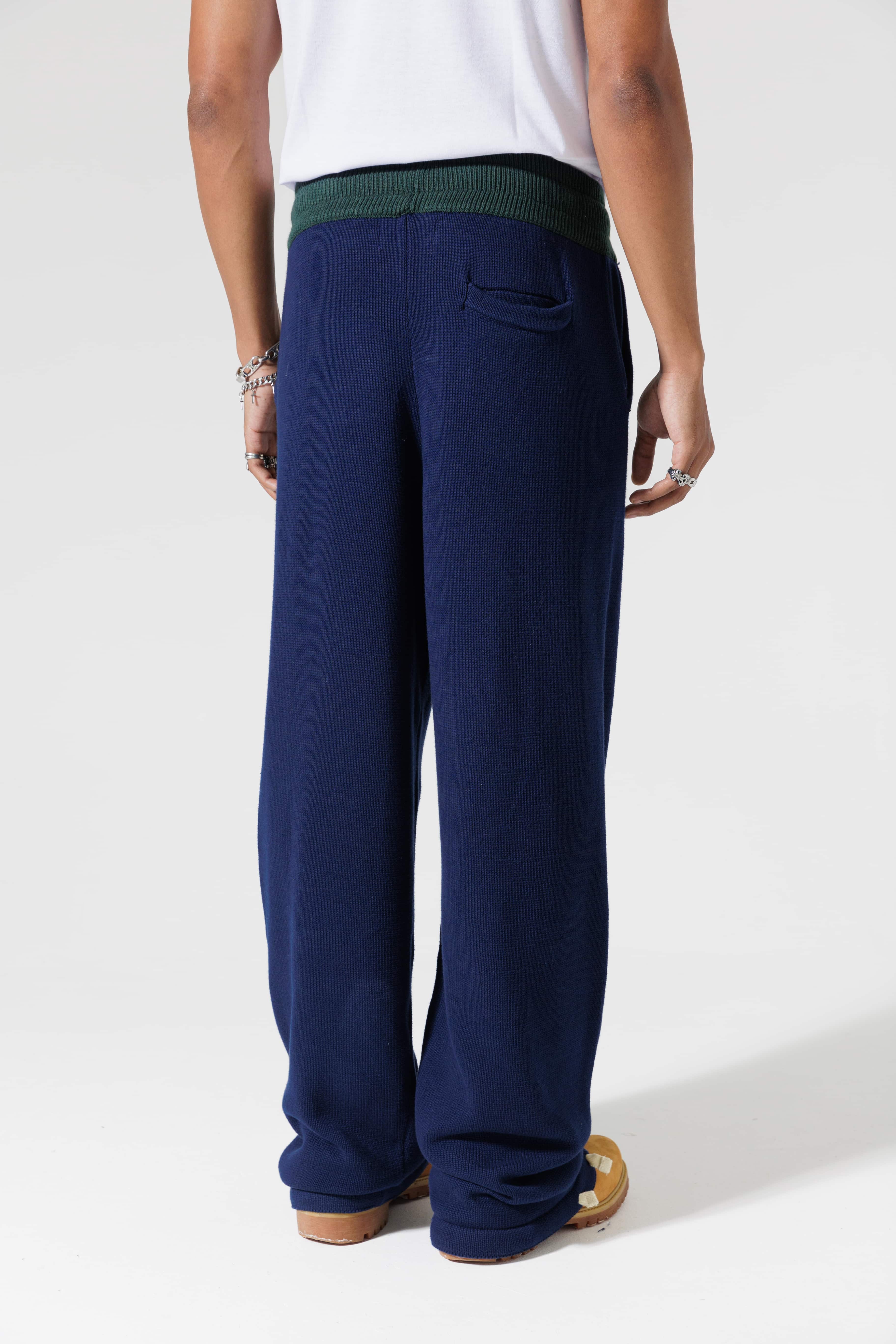 Male Model Wearing The Wisdom Of Age Knit Clinton Sweatpants Navy Rear View.