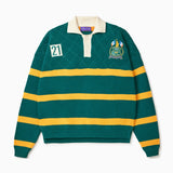 Front View of the Wisdom of age Lemon rugby. This is a Green garment with yellow stripes, a cream collar and buttons. There is a Wisdom of age NY state patch on the left shoulder and a embroidered number 21 within a cream box 