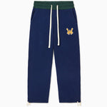 The Wisdom Of Age Knit Clinton Sweatpants Navy Front View. Embroidered Yellow WA logo with a white outline on the left mid-hip. Off-White drawstrings on a dark green waistband
