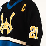 Close up WIsdom Of Age Hockey Jersey - Static Shock with yellow and blue details worn by a male model.