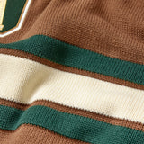 Close-up of a brown sweater with green and white stripes