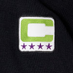 Captains patch with a neon green C and a white center on a black background