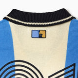 Close up Of the Wisdom Of Age Knit Soccer Jersey Celeste. Blue and beige striped Knitted Soccer Jersey with 'NY TOUGH' logo on a white background