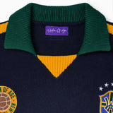 Wisdom Of Age Knit soccer jersey Rio. Black Knitted Soccer Jersey with green collar, yellow accents, and logos on a white background