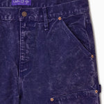Close Up Of WOA Canvas Carpenter Shorts in Purple with WOA brand label on a white background