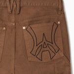 Close up of WOA Canvas Carpenter Shorts in Brick with WA logo on the right back pocket on a white background