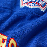Close up of the front right WOA skyline  patch on the Wisdom Of Age Knit Football Jersey in Giant Blue