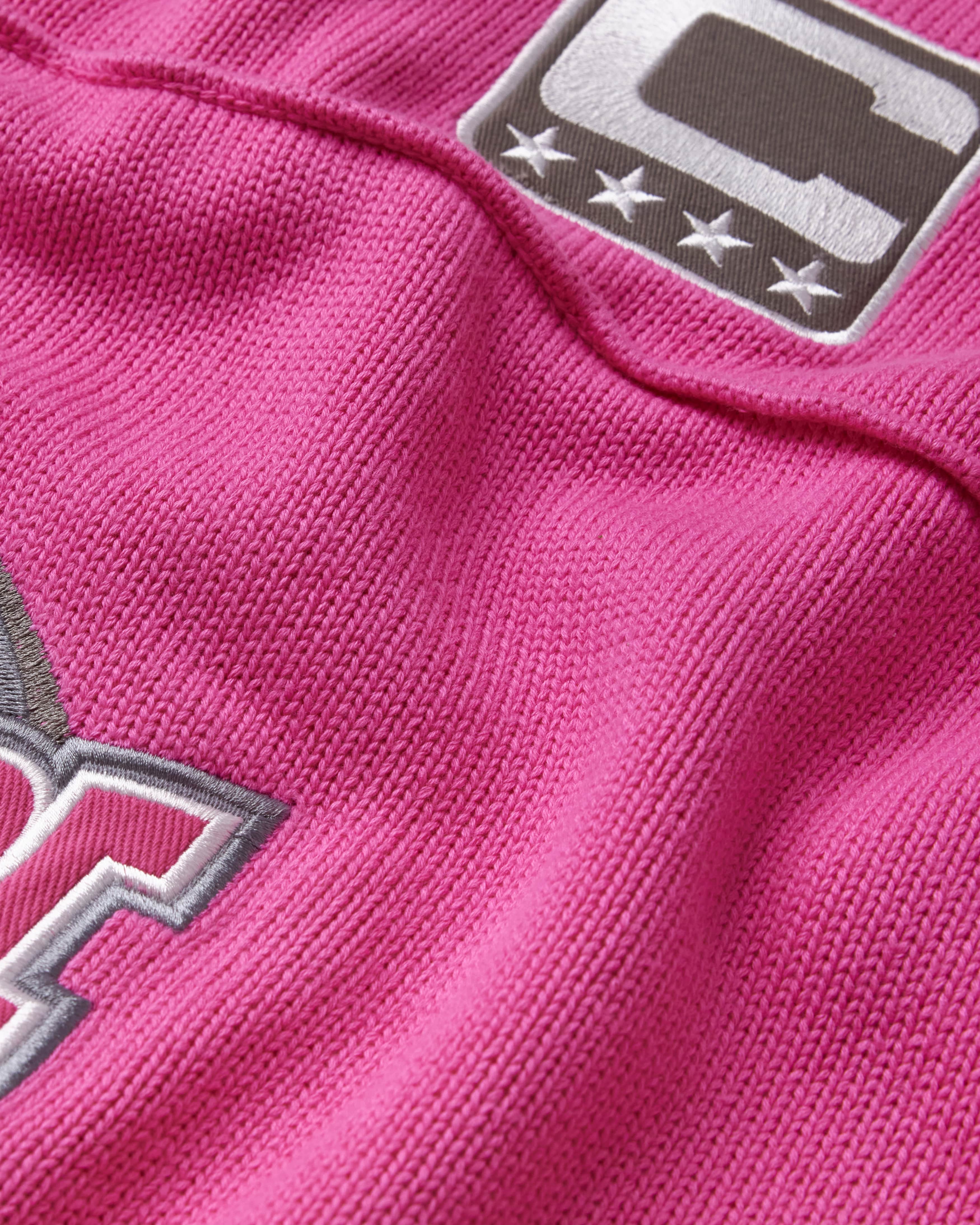 Close-up of the wisdom of age pink knitted football jersey 