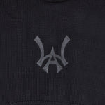 Closer look at the brand logo in a monogram font of connecting the "W" and "A" located on the front chest of the hoodie just above the kangaroo pocket.