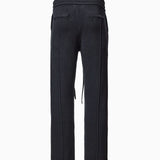 Back of Wisdom of Age Knit Sweatpants in Black. Back welt pockets and WA logo chain stitched below back right pocket on the side.