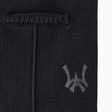 Closer look at the brand logo in a monogram font of connecting the "W" and "A" located below the right back pocket on the right leg.