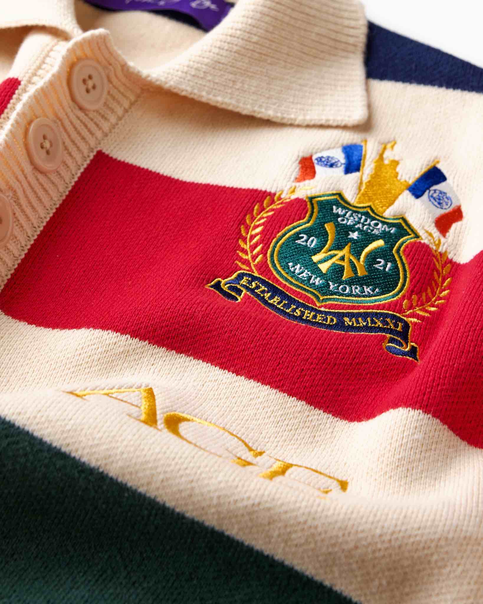 Wisdom of Age Bleecker Rugby Polo in multicolor stripes zoomed front view of premium cotton knit material and brand embroidery .